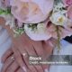 hands with a ring of the bride and groom with a wedding bouquet